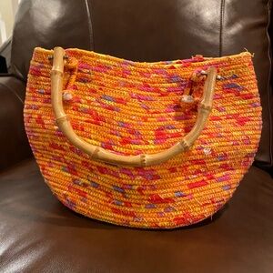 Orange/mixed color woven cloth tassel bamboo handle purse. Never used.Great swim